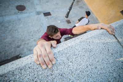 High angle view of man climbing wall