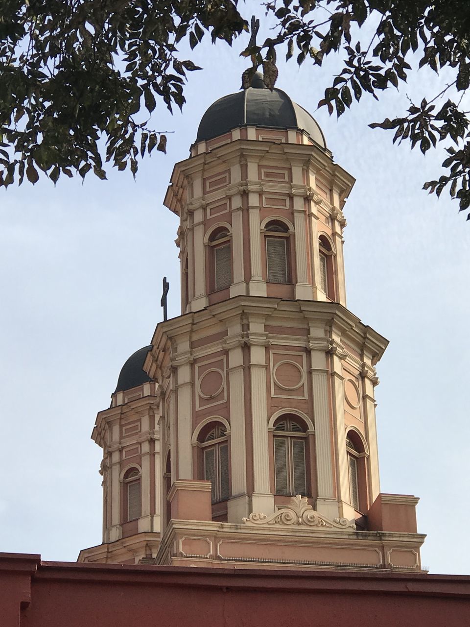 LOW ANGLE VIEW OF BUILDING AND TREES AGAINST SKY