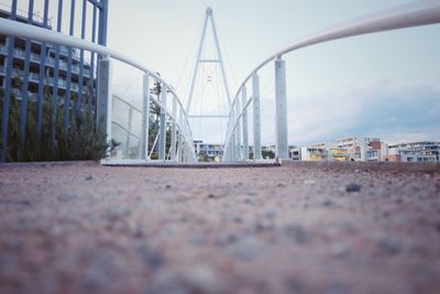 Surface level of bridge against sky in city