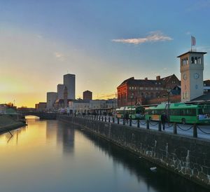 View of city at waterfront during sunset