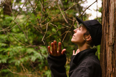 Portrait of teenage girl looking away in forest