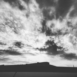 Low angle view of silhouette building against sky
