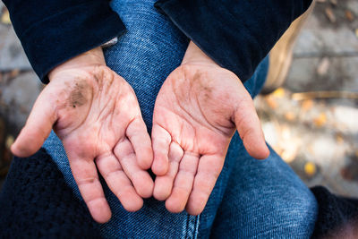 Directly above view of child showing dirty hands