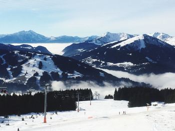 Scenic view of snow covered mountains against sky