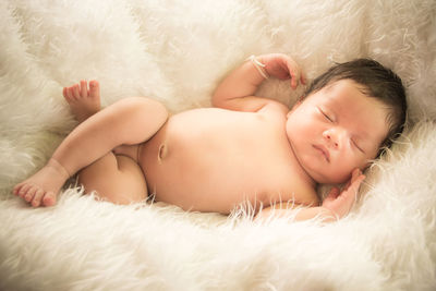 Cute baby boy sleeping on fur