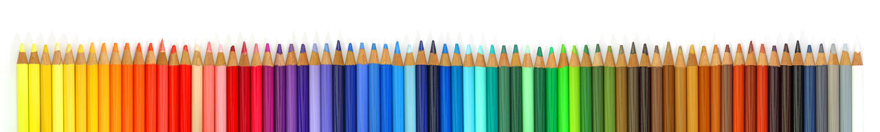 Close-up of multi colored pencils against blue background