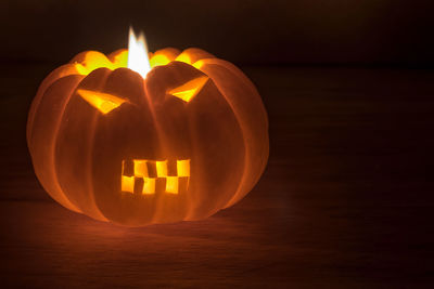 Close-up of illuminated pumpkin on table