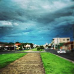 Built structure on landscape against cloudy sky