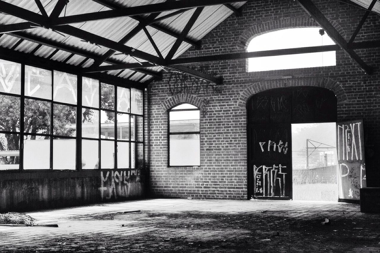 architecture, built structure, indoors, arch, building exterior, building, window, ceiling, wall - building feature, abandoned, interior, day, no people, graffiti, architectural column, sunlight, wall, old, architectural feature, empty