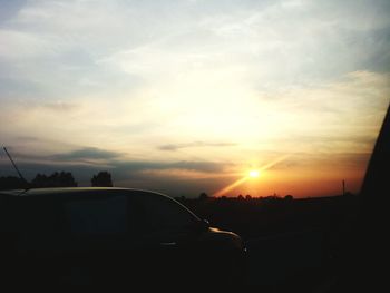 Car on road at sunset