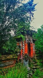 Built structure with trees in foreground