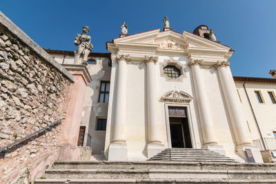 Low angle view of statue against historic building