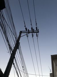 Low angle view of electricity pylon against sky