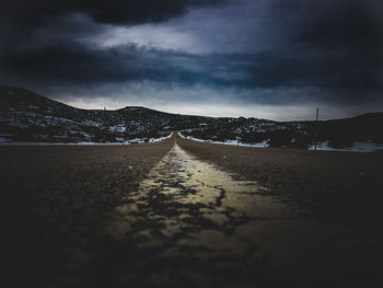 Road passing through snow covered landscape