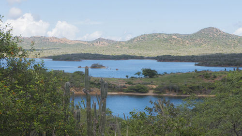 Scenic view of lake and mountains against sky