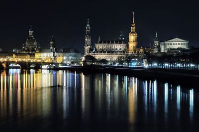 Reflection of illuminated buildings in water at night