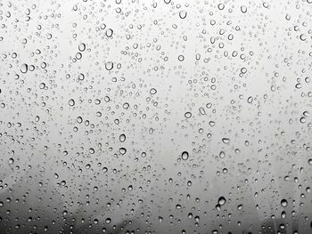 Full frame shot of raindrops on glass