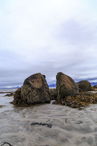 Rock formations by sea against sky