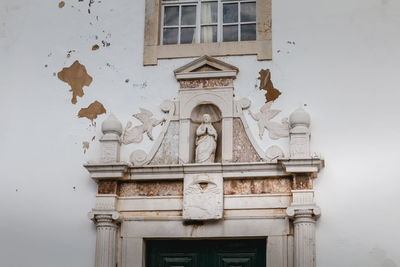 Low angle view of statue against building