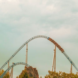 Low angle view of rollercoaster against sky