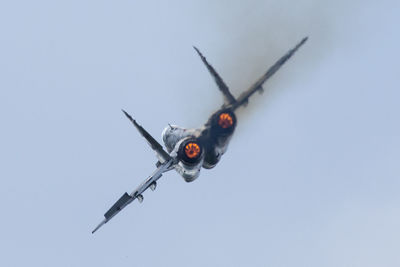 Low angle view of fighter plane flying against clear sky