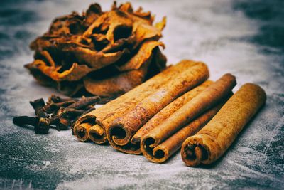 Close-up of cinnamon sticks on marble