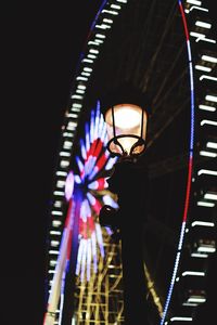 Low angle view of illuminated ferris wheel