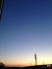 Low angle view of power lines against clear sky