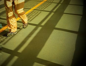 Low section of woman walking on tiled floor