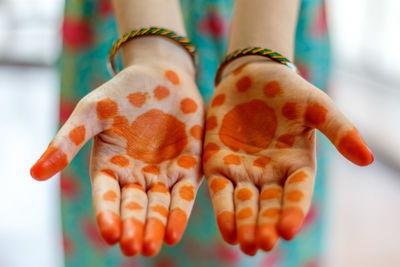 Close-up of hand holding orange