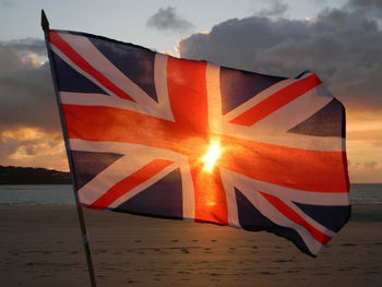 Close-up of flag against sky during sunset