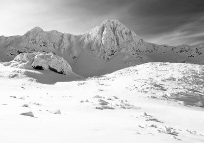 Scenic view of snow covered mountains against sky