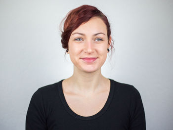 Portrait of a smiling young woman over white background