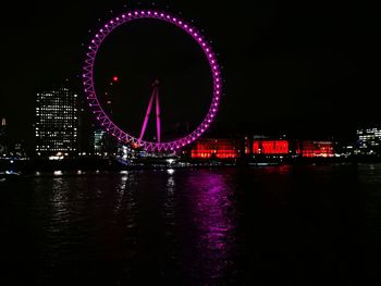 Illuminated ferris wheel at night