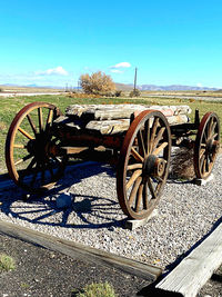 Bicycle parked on field against clear sky