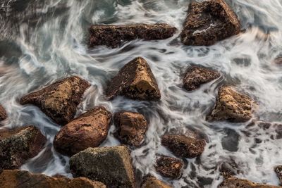 High angle view of rocks in sea