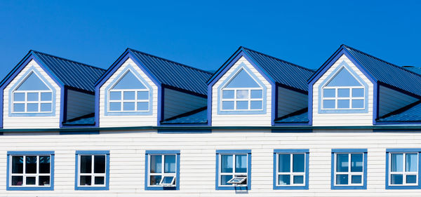 Low angle view of building against clear blue sky