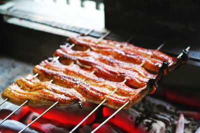 High angle view of saltwater eels being cooked on barbecue grill