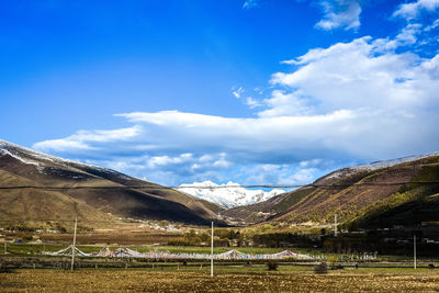 Scenic view of mountains against blue sky