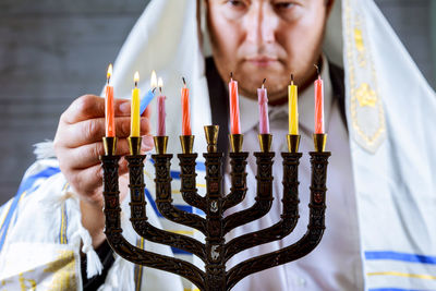 Man igniting candles in church