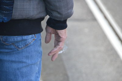 Low section of man standing outdoors