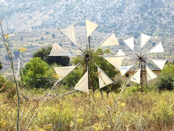 Traditional windmill on field against sky