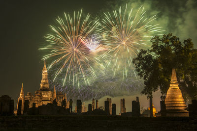 Low angle view of firework display at night