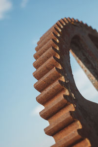 Low angle close-up of metal against sky