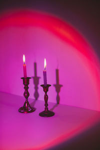 Close-up of illuminated candles on table