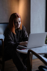 Young woman using laptop at home