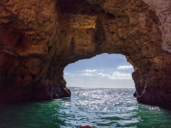 Looking through a natural arch off the algarve coast 