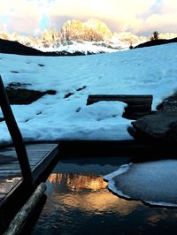 Frozen lake against sky during winter