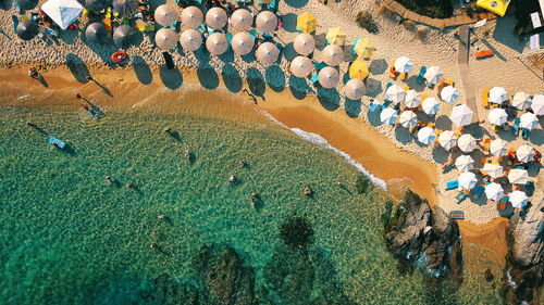 Aerial view of people on beach by rock formation