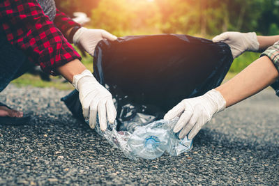 Low section of woman with hands on street